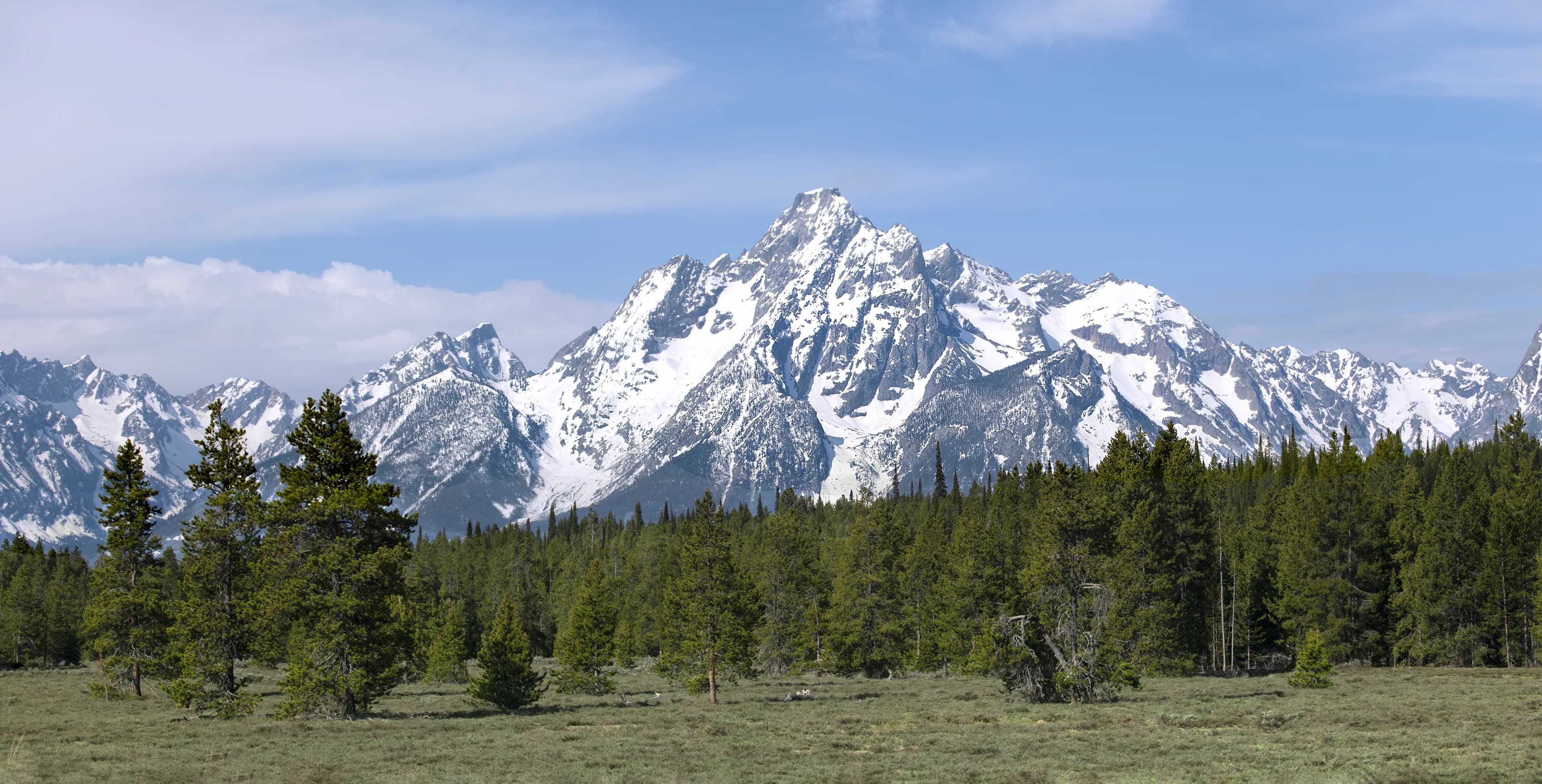 The Teton mountain range above a green valley